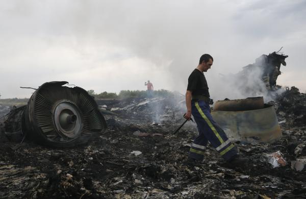 Emergencies Ministry member walks at the site of a Malaysia Airlines Boeing 777 plane crash near the settlement of Grabovo in the Donetsk region