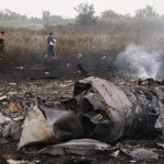 Emergencies Ministry members walk at the site of a Malaysia Airlines Boeing 777 plane crash near the settlement of Grabovo in the Donetsk region